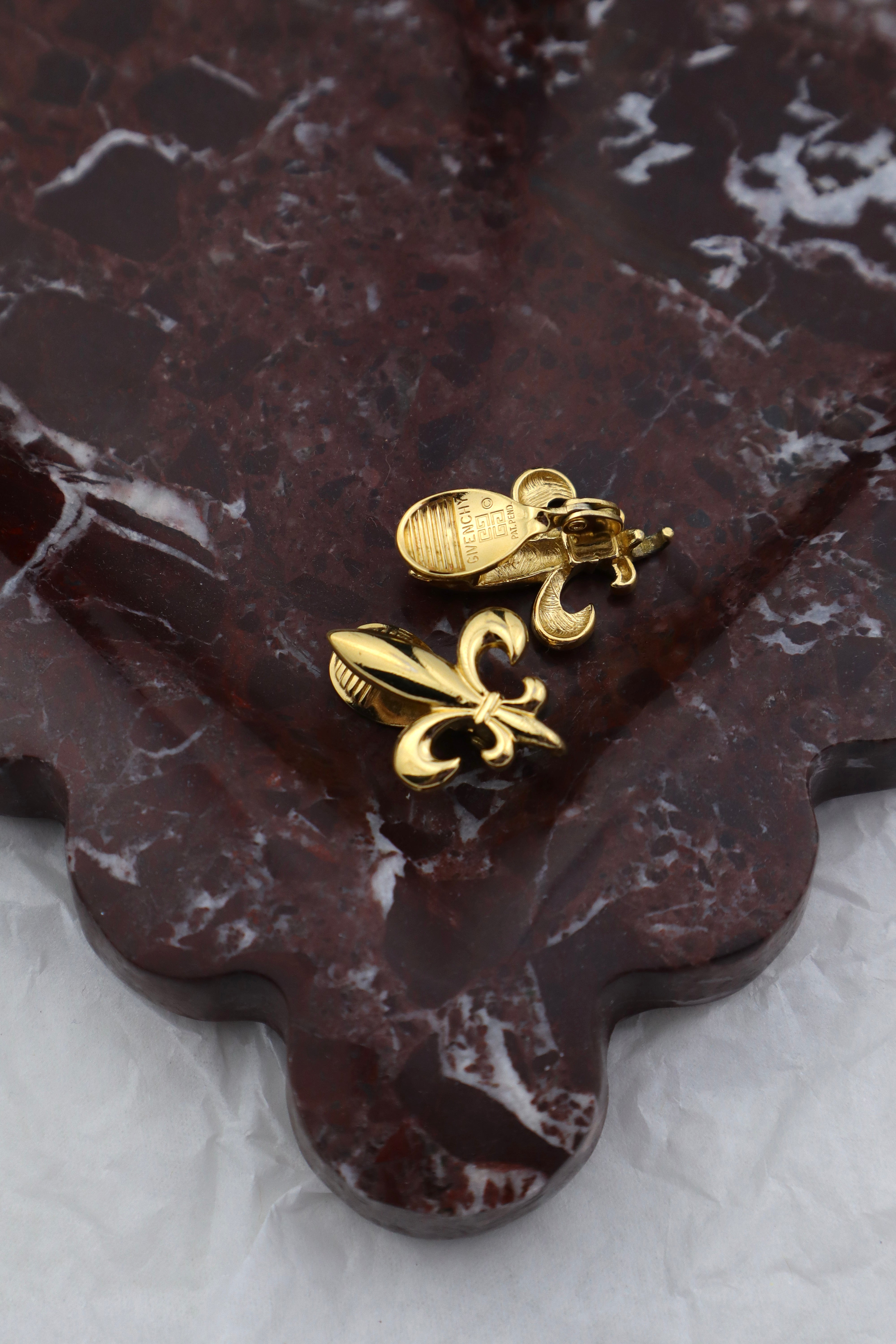 Givenchy - złocone klipsy z motywem fleur‑de‑lis